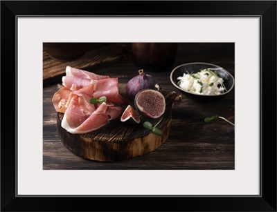 Prosciutto Slices With Figs On A Dark Wooden Background, Appetizer From Dry Cured Ham