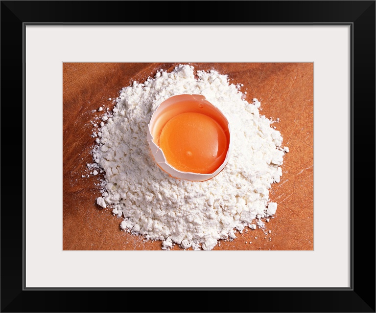 Raw egg sitting on wheat flour