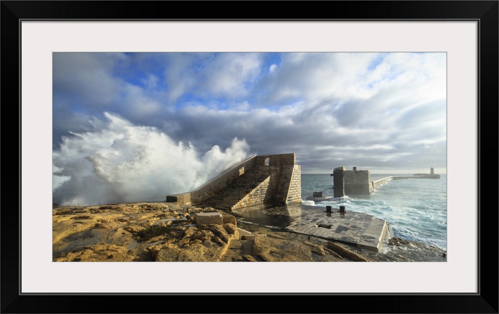 Rough seas crashing against one of Malta's most prominent breakwater.