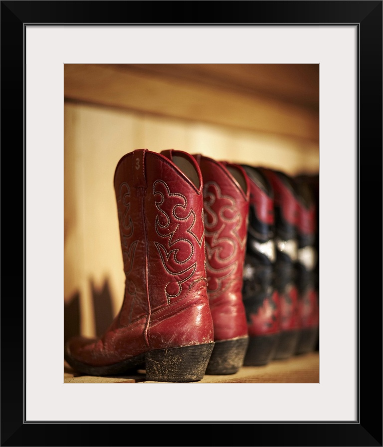 Row of cowboy boots sitting on a shelf