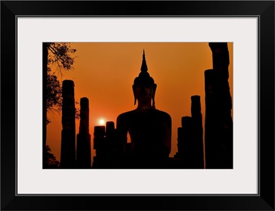 Silhouette Of Ancient Buddha Statue Sitting In Middle Of Ruined Temple
