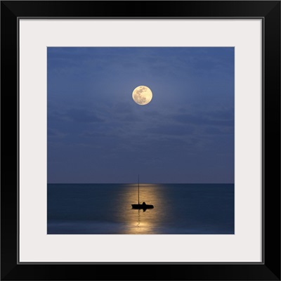 Silhouette sailboat with moon