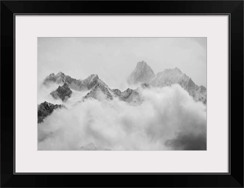 Atmospheric clouds linger around the peaks of the Swiss alps after a spring snow storm.