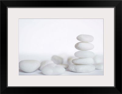 Stack of white pebbles on white background.