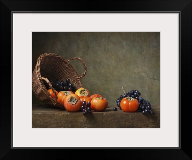 Still life with persimmons and grapes on the table.