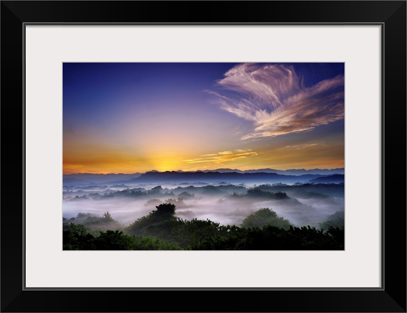 Mist over mountain at sunrise.