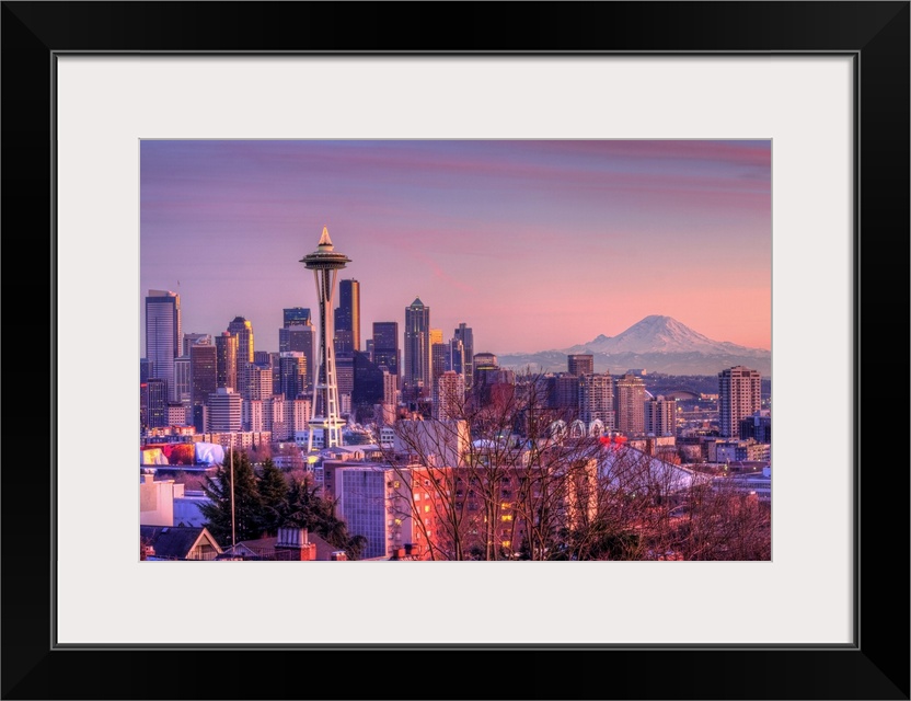 Large photo on canvas of downtown Seattle bathed in warm light from a setting sun.