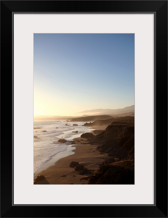 Summer sunset along california highway 1 along Big Sur between Monterey and San Luis Obispo with mountains, highway and th...
