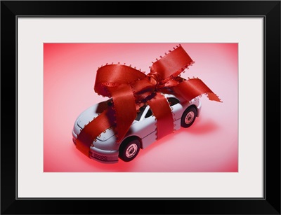 Toy car wrapped in ribbon