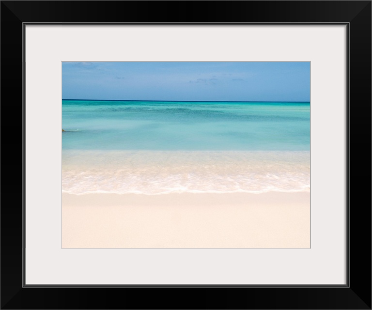 Horiztonal wall art of a serene beach and a still sea on a clear day in Aruba.