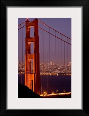 USA, California, San Francisco, Golden Gate Bridge, north tower with cityscape, night
