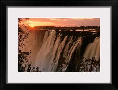 Victoria Falls with sun on horizon, Victoria Falls, Zimbabwe