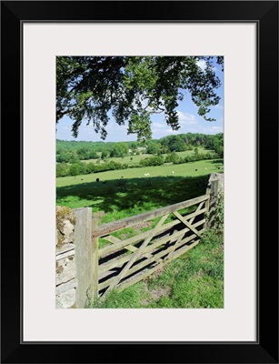 View of gate and farmland in english cotswolds.