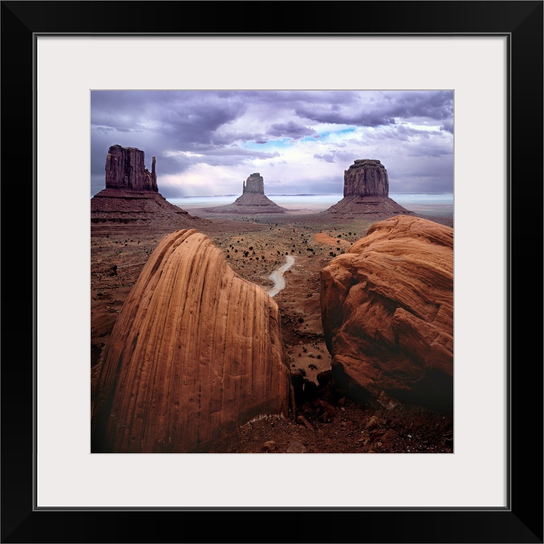 A photograph of monument valley under a purple cloudy sky.