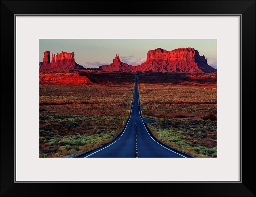 Photograph of a road dividing the Arizona and Utah deserts.