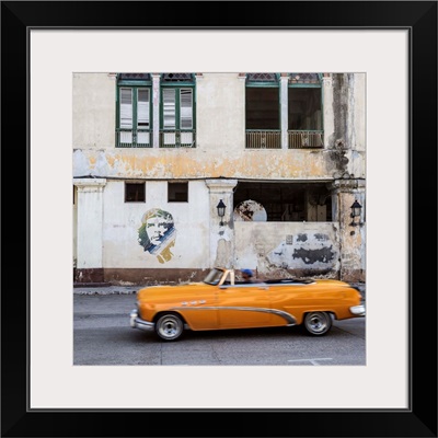 50's Classic American car passing a mural of Che Guevara, Habana Vieja, Havana, Cuba