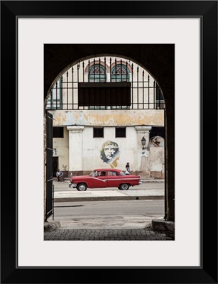50's Classic American car passing a mural of Che Guevara, Habana Vieja, Havana, Cuba