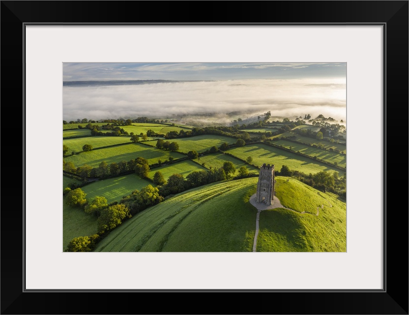 Aerial view of St. Michael's Tower on Glastonbury Tor on a misty autumn morning, Somerset, England. Autumn (September) 2020.