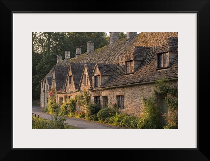 Picturesque cottages at Arlington Row in the Cotswolds village of Bibury, Gloucestershire, England. Summer (July)