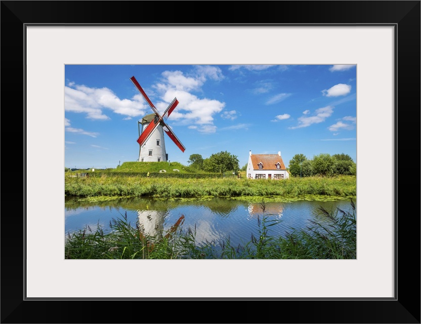 Belgium, West Flanders (Vlaanderen), Damme. Hoeke Mill (Hoekemolen) windmill on the Damse Vaart canal.