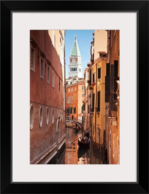 Campanile and gondola on canal in Venice, Italy