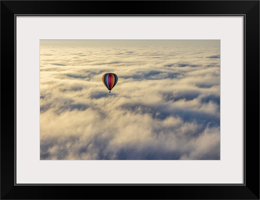 Hot air balloon above low cloud, Yarra Valley, Victoria, Australia.