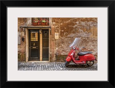 Parked Red Vespa Scooter In A Cobbled Street Of Rome, Lazio, Italy