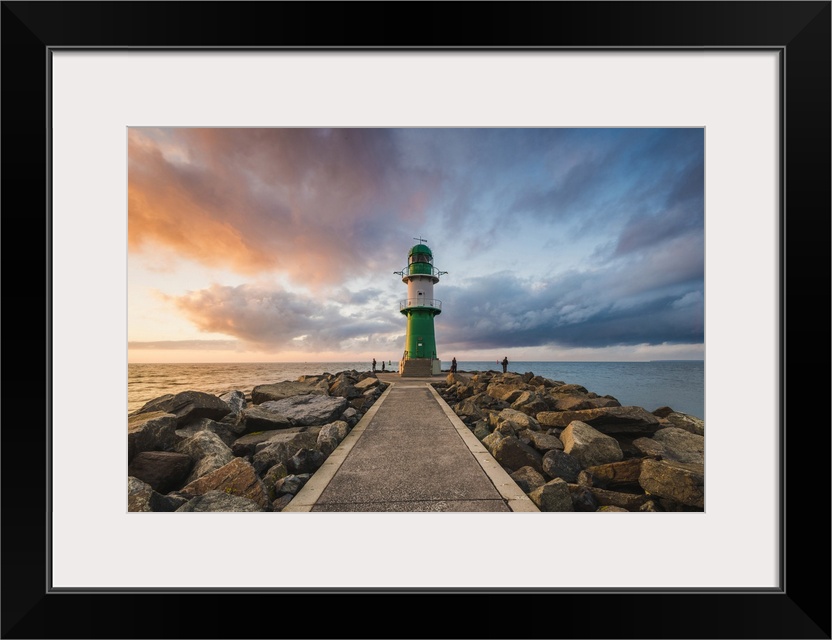 Warnermunde, Rostock district, Baltic coast, Mecklenburg-Western Pomerania, Germany. Pier to the lighthouse at sunset.