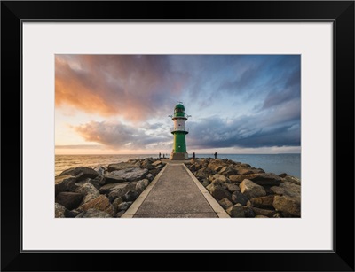 Pier to the lighthouse at sunset