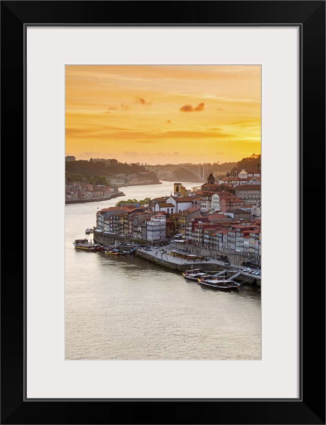 Portugal, Douro Litoral, Porto. Sunset over the UNESCO listed Ribeira district, viewed from Dom Luis I bridge.