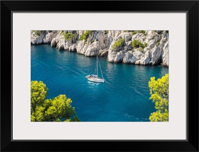 Sailboat Passing Through Emerald Blue Water Of Calanque De Port-Pin, France