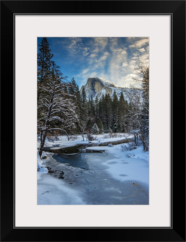 Winter view over icy Tenaya creek with Half Dome mountain behind, Yosemite National Park, California, USA