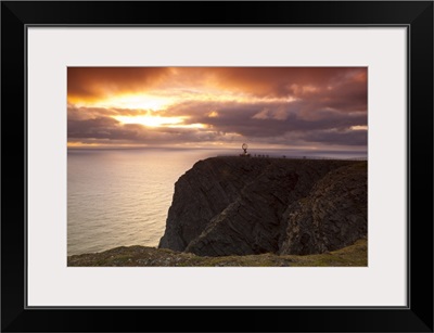 The Midnight Sun breaks through the clouds at Nordkapp, Finnmark, Norway