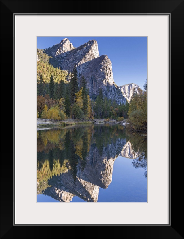 The Three Brothers reflected in the Merced River at dawn, Yosemite Valley, California, USA. Autumn (October)