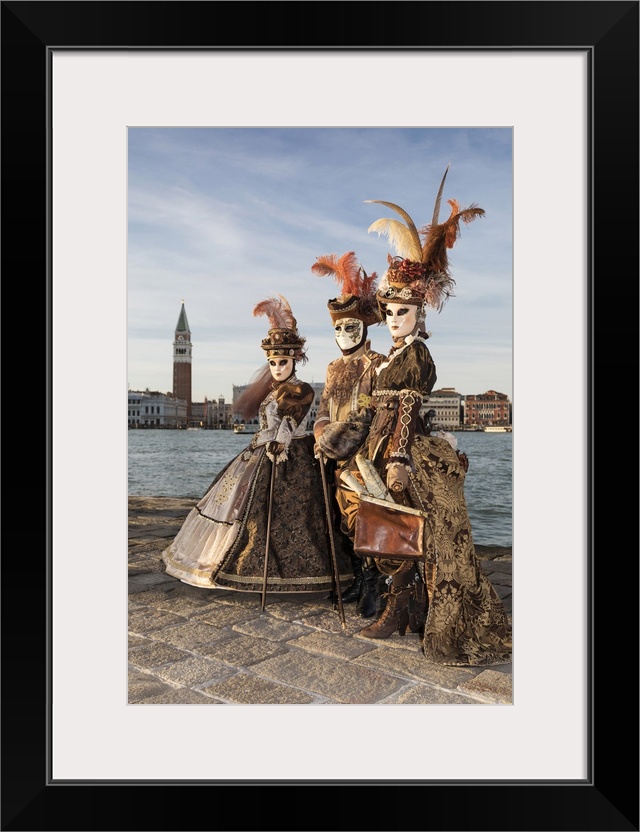 Three people in costume at Carnival time, San Giorgio Maggiore, Venice, Veneto, Italy