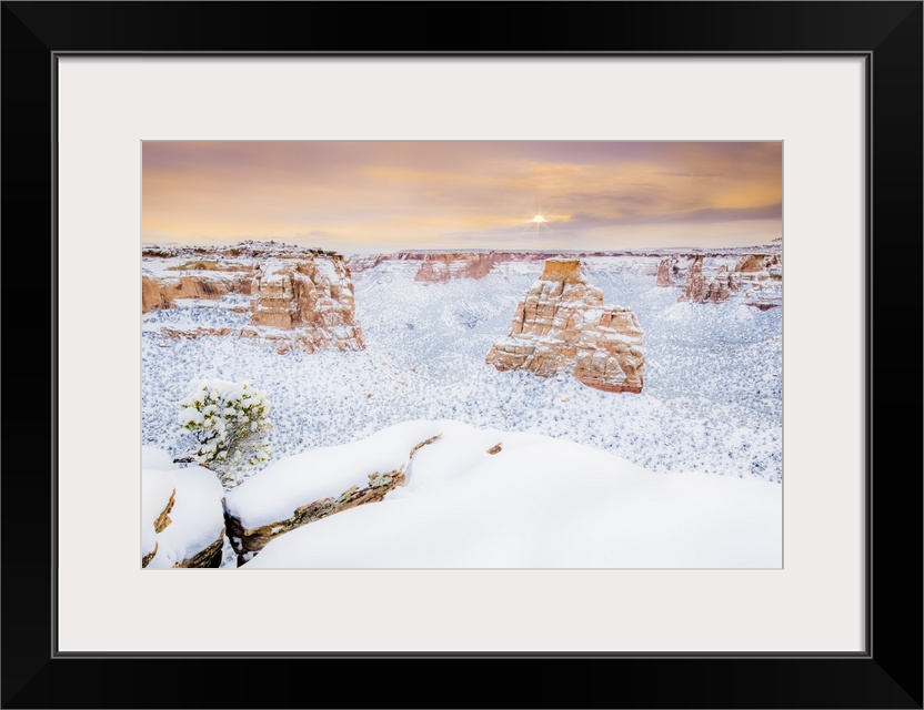 Sun rises over the landscape of fresh snow, Colorado National Monument