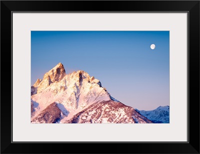 The Moon Sets As Sun Rises Over Grand Teton's Peak; Grand Teton National Park, Wyoming