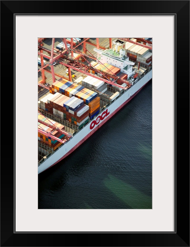 Crane loading cargo onto container ship, Port of Seattle, WA - Aerial Photograph