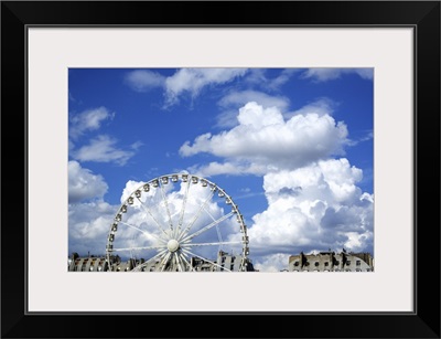 A ferris wheel in Paris, France, on a cloudy day