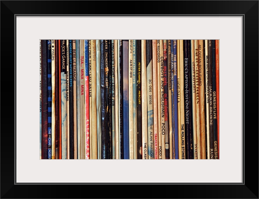 Big photograph shows a large collection of LP vinyl records that includes works from artists such as Eric Clapton, Billy J...