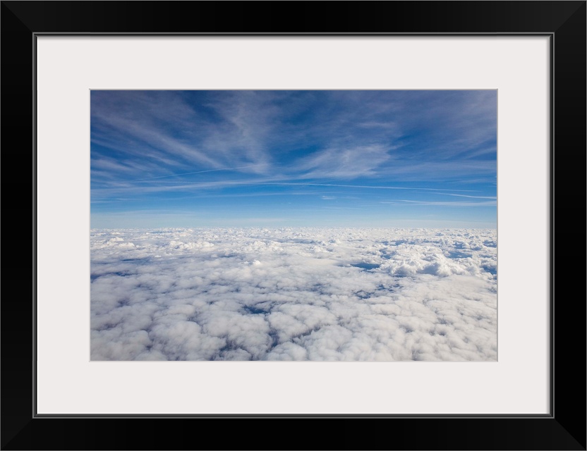 Just above the clouds, the sky split into blue and white layers.