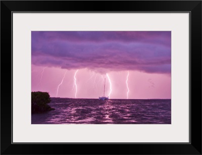 Lightning bolts striking the ocean, and almost hitting a sailboat