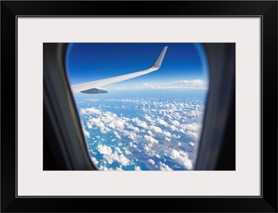 View through a passenger airplane window flying over the Caribbean