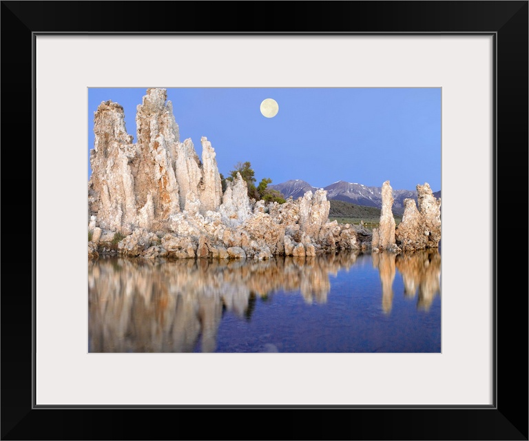 Full moon over Mono Lake with wind and rain eroded tufa towers and the eastern Sierra Nevada Mountains in the background, ...