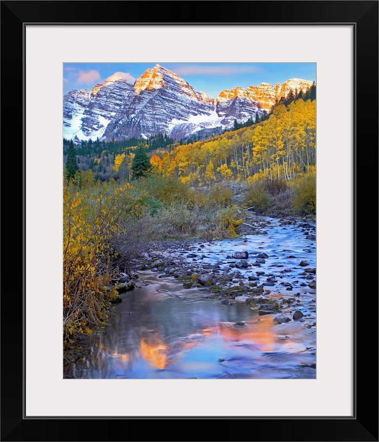 Vertical wall art photograph of a rock filled stream running through an aspen tree filled meadow in the Rocky Mountains.