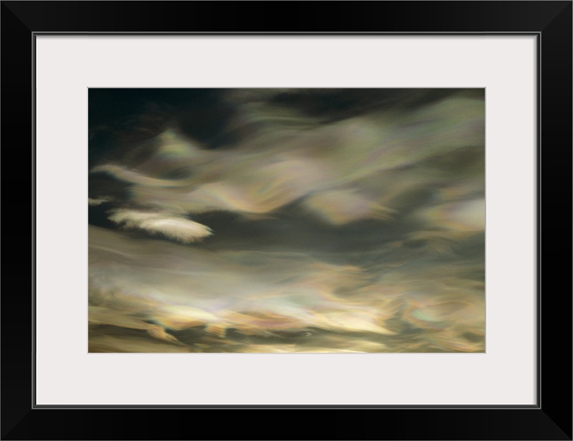 An abstract artwork piece of clouds in a winter sky. There is a pearl essence and wave like appearance to the clouds.