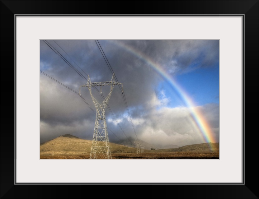 Powerlines, rainbow forms as evening sun lights up rain clouds, Canterbury, New Zealand