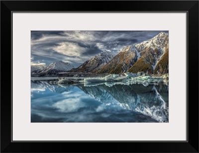 Reflection of clouds, peaks and icebergs in lake, Tasman Glacier, New Zealand