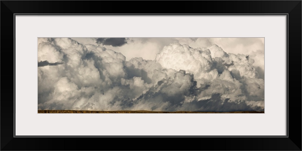 Heavy cumulus clouds gather before storm above sagebrush desert, central Wyoming