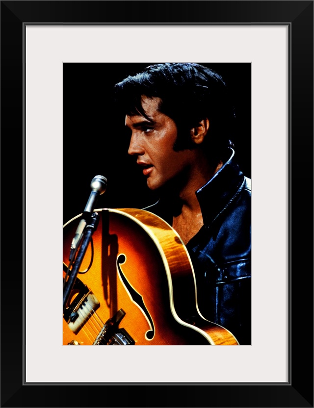 Big canvas photo of an up close shot of Elvis Presley holding a guitar in front of a microphone.